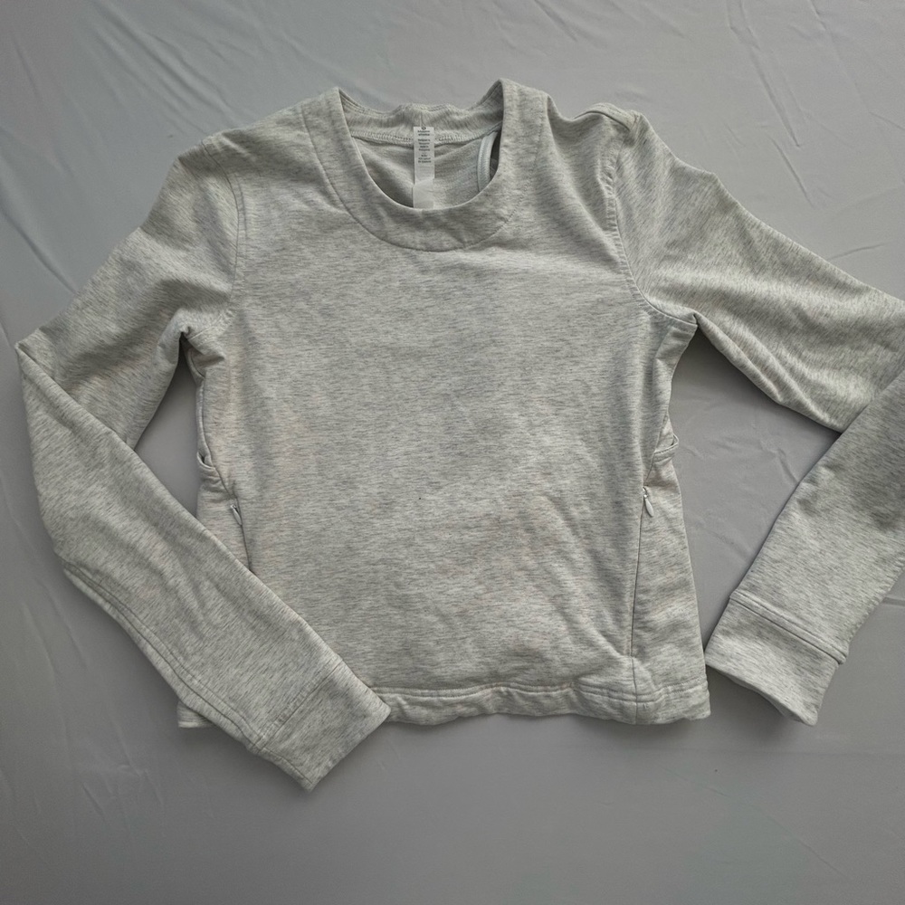 Lululemon light grey pullover with cut out back design. Size 2. Worn Once!